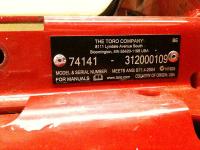 Model and serial numbers located at the front of the mower, below the seat, on the left-hand side.