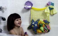 Picture of Girl Smiling at Toy Netting in Bathtub